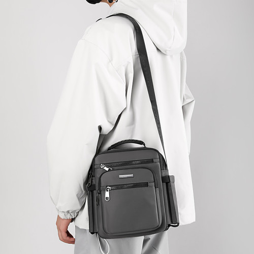 斜後後背包男大容量牛津布新款通勤郵差包男士戶外放水杯爸爸斜背後後背包