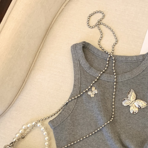 專櫃撤廻剪標小香風蝴蝶別針吊帶背心女夏季新款外穿不規則短上衣